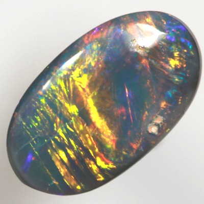 SOLID BLACK OPAL Bright neon golds, yellow and red over blue